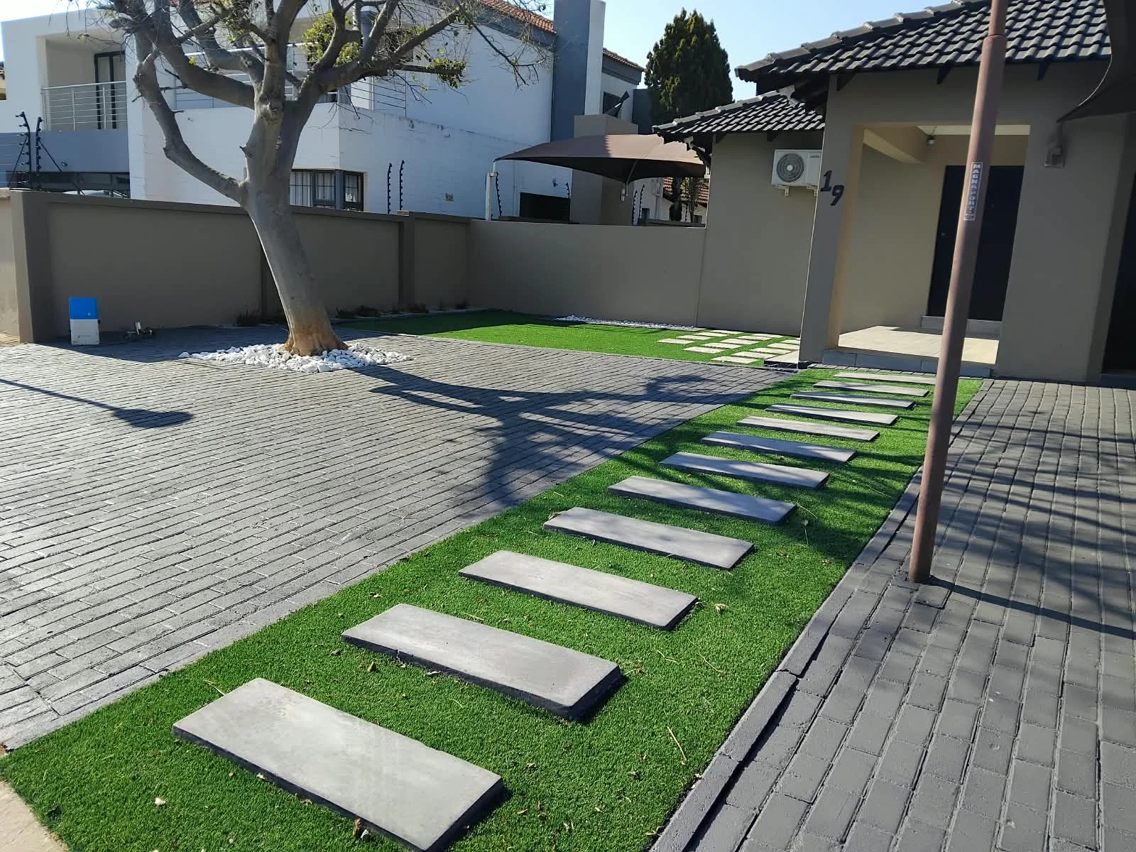 Landscaped garden design with a stone pathway winding between plants